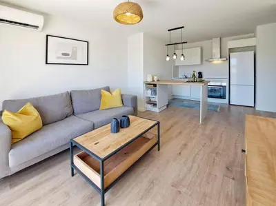 a living room with a couch and a table at Charming flat close to the beach in Canet de Berenguer
