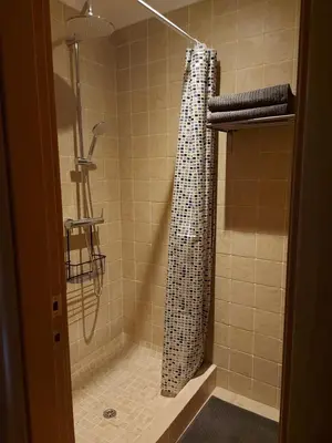 a shower with a shower curtain in a bathroom at Posada la Toscana in Montroy