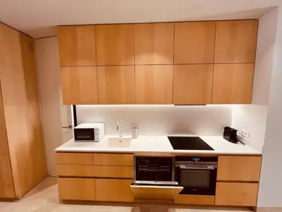 a kitchen with wooden cabinets and a sink at BET Apartments - Central Market Apartments in Valencia