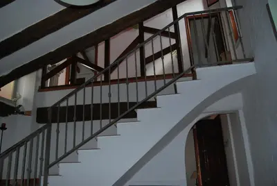 a staircase in a house with wooden railings at CortijoRamon in El Brosquil