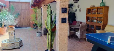a room with potted plants on a brick floor at CortijoRamon in El Brosquil