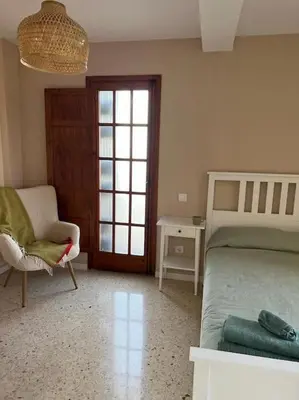 a bedroom with a bed and a chair and a window at Modern apartment in Valencia, Port Saplaya, by the sea in Port Saplaya