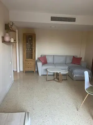 a living room with a couch and a table at Modern apartment in Valencia, Port Saplaya, by the sea in Port Saplaya