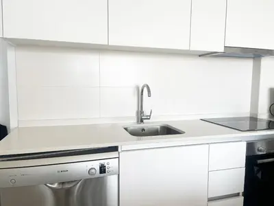 a white kitchen with white cabinets and a sink at Global Vacacional, Nuevo apartamento con terraza en Gran Canet Residencial in Canet de Berenguer