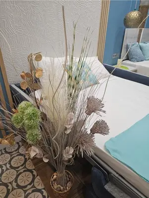 a vase filled with plants sitting next to a bed at Lounge garden sea relax in Valencia
