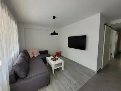 a living room with a couch and a table at New and Bright 2-bedroom apartment in Cañamelar in Valencia