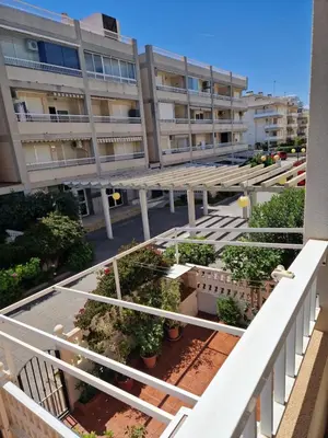 a kitchen and dining room with a table and a couch at V&M Canet in Canet de Berenguer