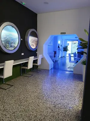 an office with a meeting room with a table and chairs at CAPSULE INN VALENCIA Hostel in Valencia