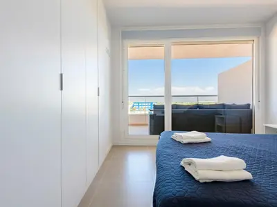 a bedroom with a bed with two towels on it at Apartment Gran Canet by Interhome in Canet de Berenguer