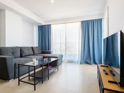 a living room with a couch and a tv at Apartment Gran Canet by Interhome in Canet de Berenguer