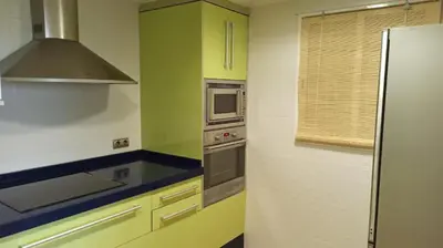 a kitchen with a refrigerator and a microwave at Faro Cullera primera Linea Playa del Dosel in Faro de Cullera