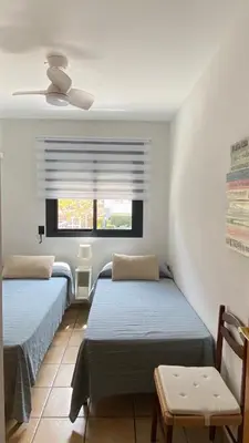 two beds in a room with a window at Residencial Playa Canet in Canet de Berenguer