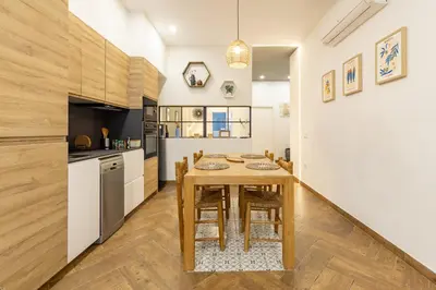a kitchen with a wooden table in a room at La Peregrina in Valencia