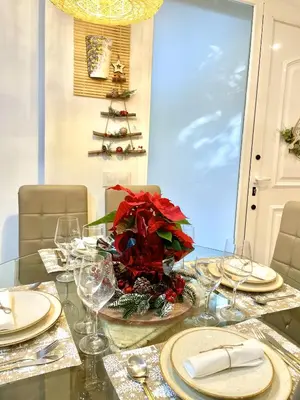 a dining room table with a christmas centerpiece on it at Fantastic apartment near beach & Science City in Valencia