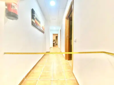 a hallway with a yellow caution tape on the wall at Fantastic apartment near beach & Science City in Valencia