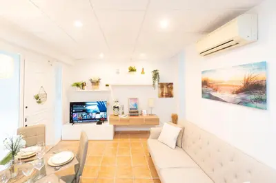 a living room with a couch and a table at Fantastic apartment near beach & Science City in Valencia