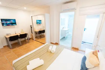 a living room with a couch and a dining room at Fantastic apartment near beach & Science City in Valencia