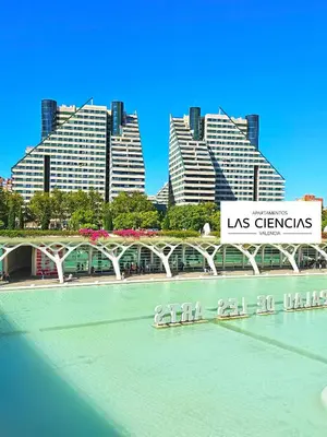 a bridge over a river with buildings in the background at Apartamentos Las Ciencias F in Valencia