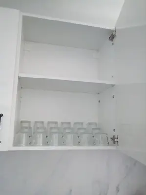 a white shelf with empty chairs in a room at Spacious, 2 BR/2 BA, 3 Min walk to the beach in Cullera