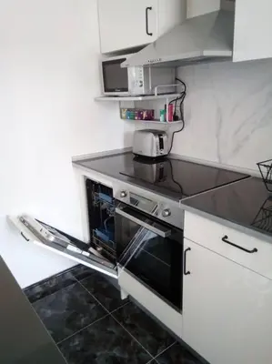 a kitchen with a stove and a microwave at Spacious, 2 BR/2 BA, 3 Min walk to the beach in Cullera