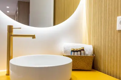 a bathroom with a white sink and a mirror at Apartamentos Las Ciencias K in Valencia