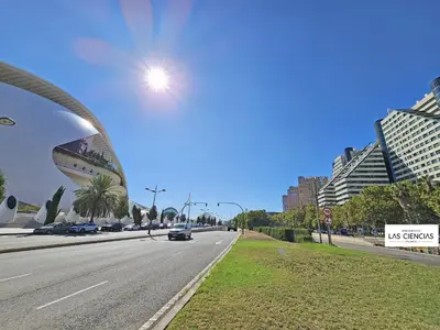 a city street with a car driving down a road at Apartamentos Las Ciencias L in Valencia