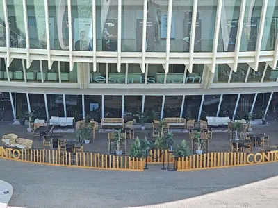 a building with tables and chairs in front of it at Apartamentos Las Ciencias E in Valencia