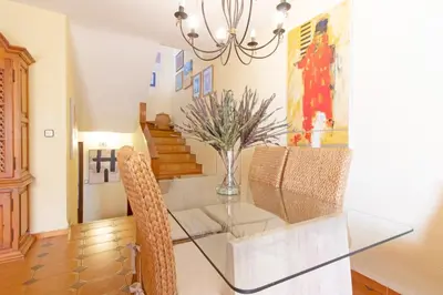 a dining room with a glass table and chairs at Global Vacacional, Adosado con piscina en la playa de Canet in Canet de Berenguer