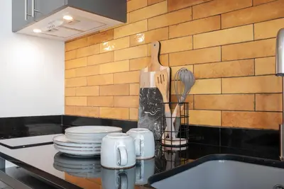 a kitchen counter with plates and utensils and a sink at Precioso Loft en Valencia in Valencia