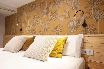 a bedroom with a bed with yellow and white pillows at Precioso Loft en Valencia in Valencia