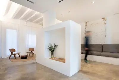 a person walking through a living room with a couch at Casa cristo 37 navarrés in Navarrés