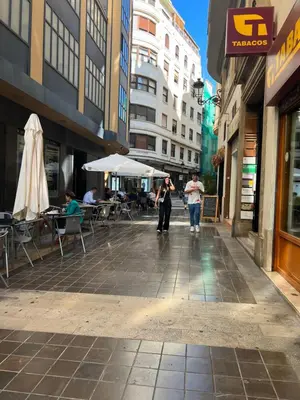 a couple of people walking down a city street at Valencia Aparthotel COSMO in Valencia