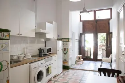 a white kitchen with a sink and a dishwasher at 4 - Acogedora habitación junto a Ruzafa con baño privado y aire acondicionado in Valencia