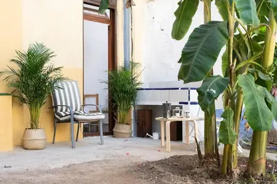 a patio with a table and chairs and plants at 4 - Acogedora habitación junto a Ruzafa con baño privado y aire acondicionado in Valencia