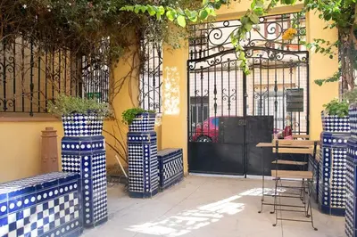 a building with a gate and a table and chairs at 4 - Acogedora habitación junto a Ruzafa con baño privado y aire acondicionado in Valencia