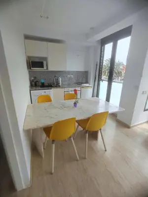 a kitchen with a table and chairs in a room at Bright loft near the sea + BIKES in Valencia