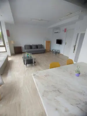 a large room with a table and a couch at Bright loft near the sea + BIKES in Valencia