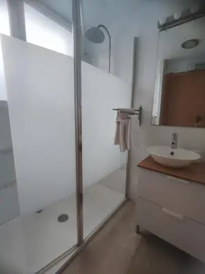 a bathroom with a shower and a sink and a mirror at Close to the sea, large (170 m2) apartment+BIKES in Valencia