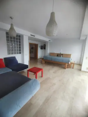 a living room with a couch and a table at Close to the sea, large (170 m2) apartment+BIKES in Valencia