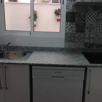 a kitchen counter with a sink and two mirrors at Oceanográfico, Playa, Puerto Juanjo in Valencia