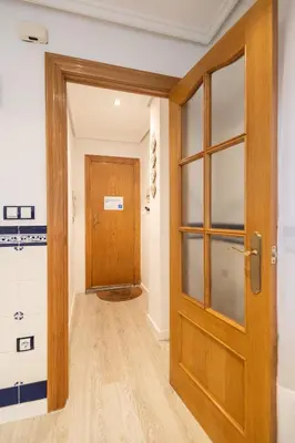 a room with a wooden door and a hallway at La casita de pescadores by Concept Flats in Valencia