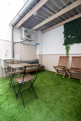 a room with a picnic table and benches on grass at La casita de pescadores by Concept Flats in Valencia