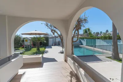 an arched entryway to a house with a pool at Exquisita Villa Frente al Mar in Sagunto