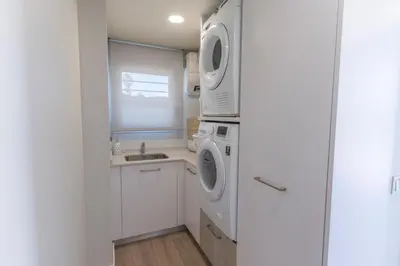 a kitchen with a washing machine and a sink at Exquisita Villa Frente al Mar in Sagunto