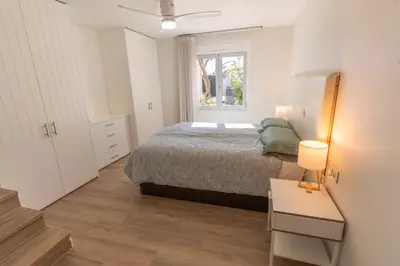 a small bedroom with a bed and a window at Exquisita Villa Frente al Mar in Sagunto