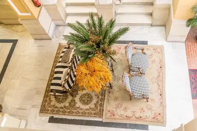 an aerial view of a lobby with a palm tree on a rug at Palacio de Rojas by Moontels in Valencia