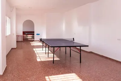 a room with a ping pong table in the middle of it at Florazar I frente a la playa in Cullera