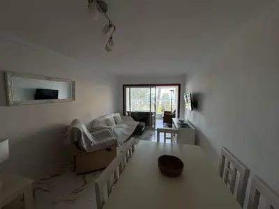 a living room with a couch and a table at Florazar I frente a la playa in Cullera
