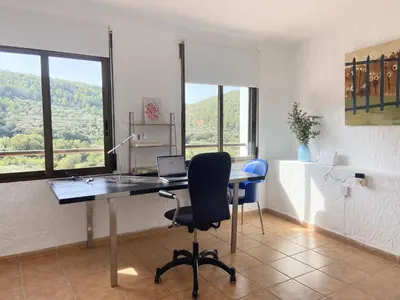 an office with a desk with a laptop and a chair at Remote Work in Spanish Mediterranean Countryside in Vall de Almonacid