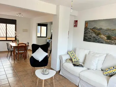 a living room with a white couch and a table at Remote Work in Spanish Mediterranean Countryside in Vall de Almonacid